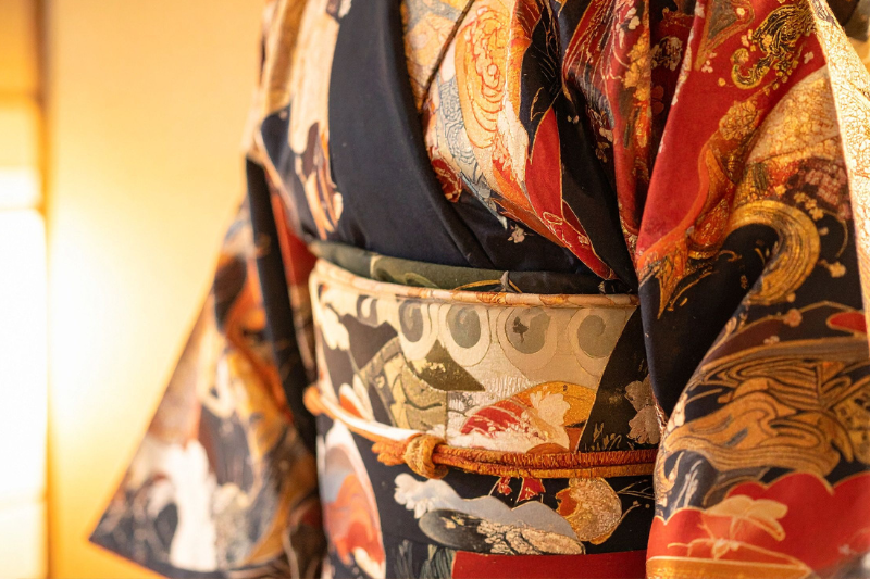 A close-up of a traditional Japanese kimono featuring intricate patterns and an elaborately designed obi.