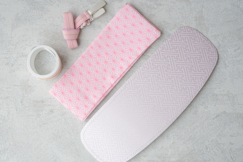 Eri-shin, korin belt, datejime, and obi-ita arranged on fabric