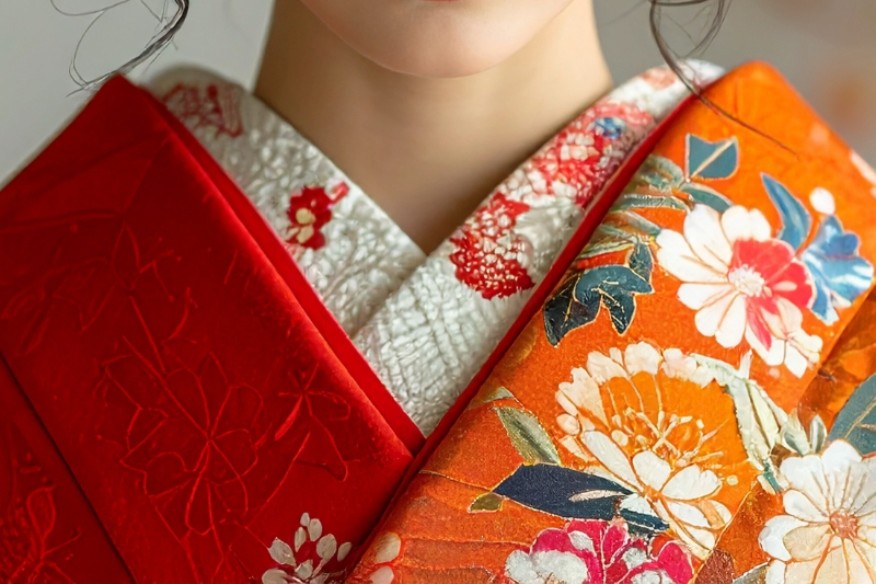 Close-up of a completed kimono neckline, showing a decorative haneri attached to the nagajuban as part of kimono dressing.